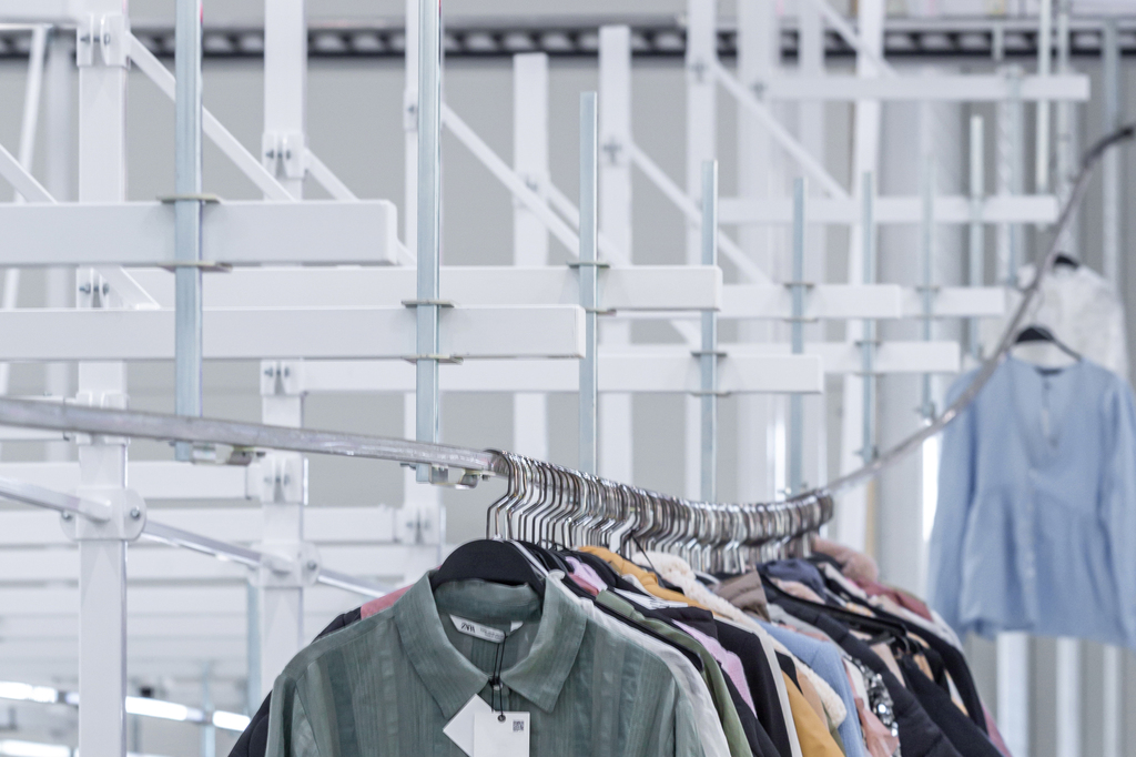 garments on hangers moved by garment rails